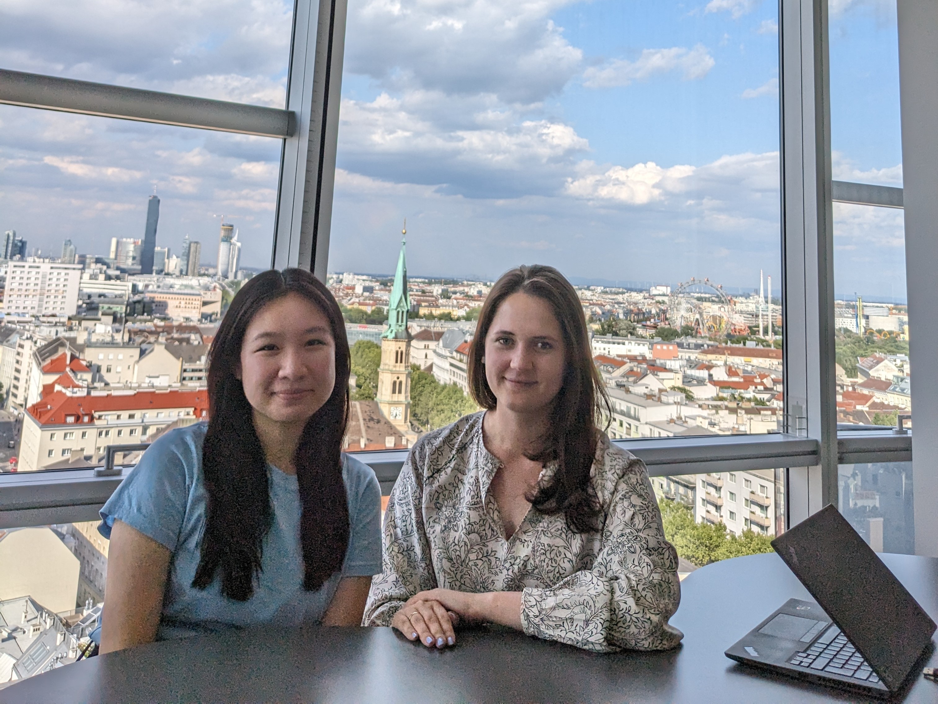 Two women are smiling at a camera.