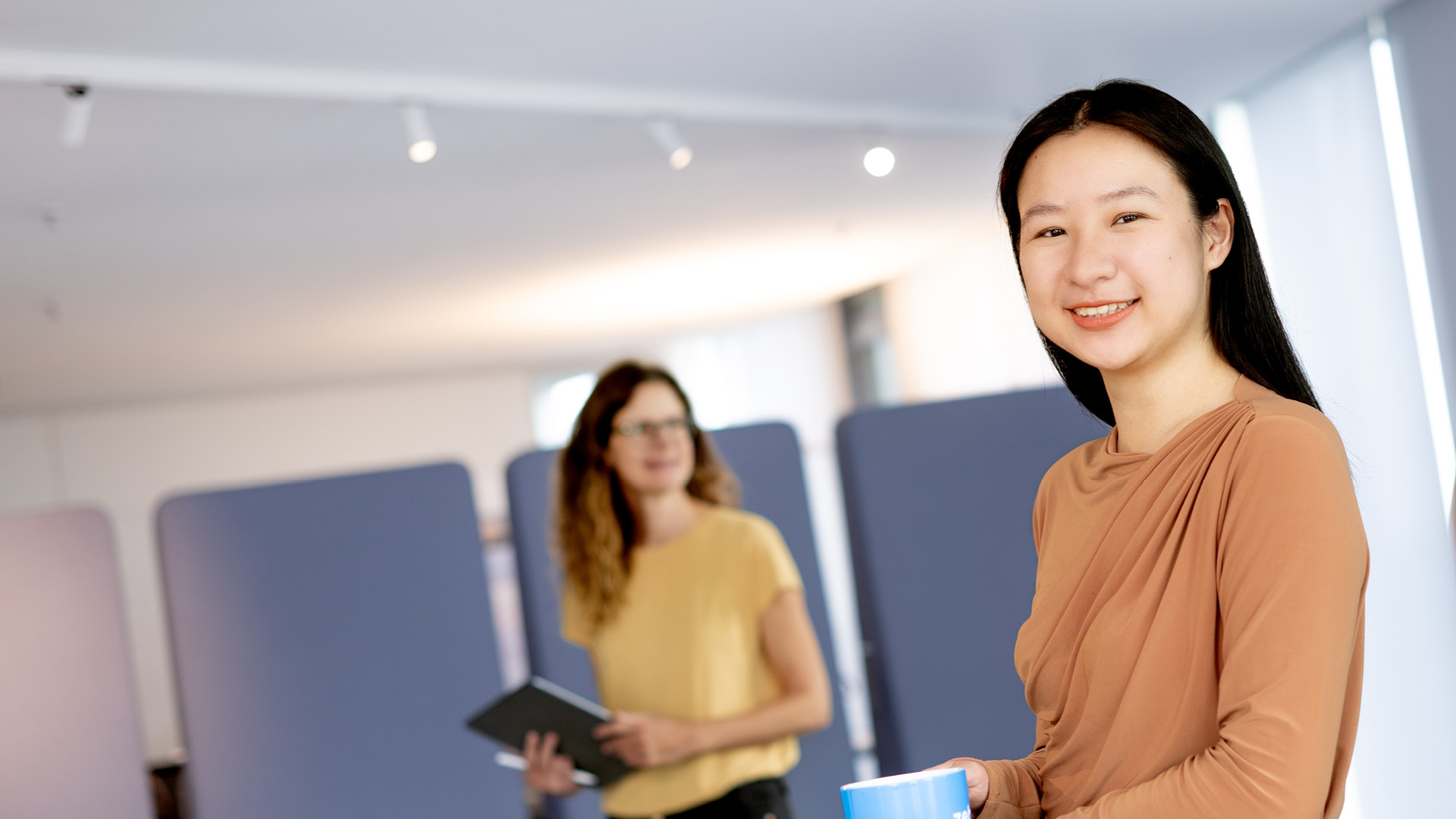 Eine Frau, die in die Kamera lächelt