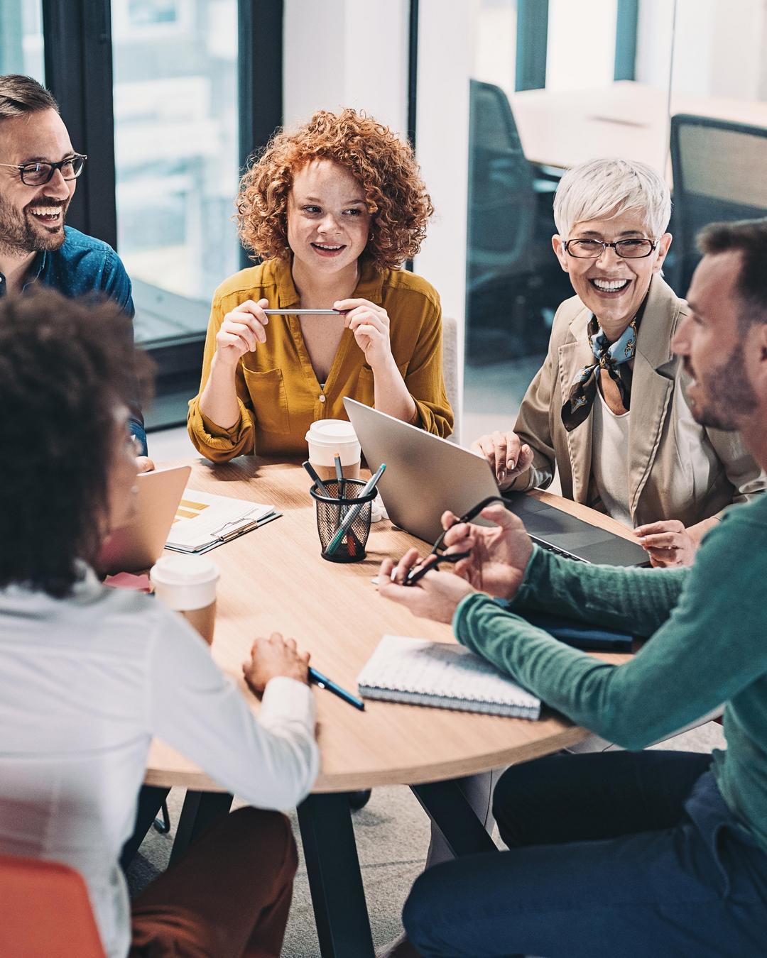 A group discusses something while sitting at a table