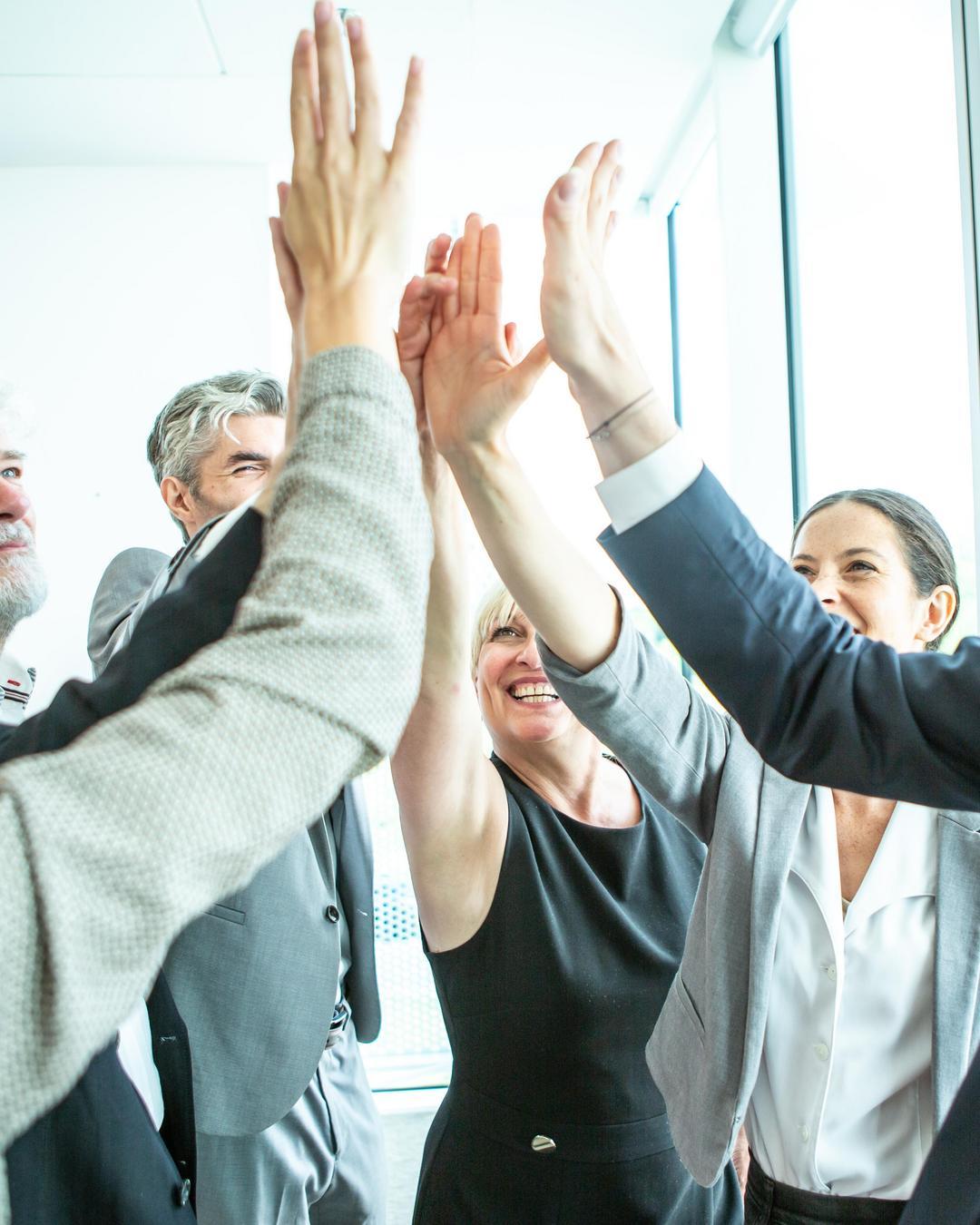 A group giving a high-five.