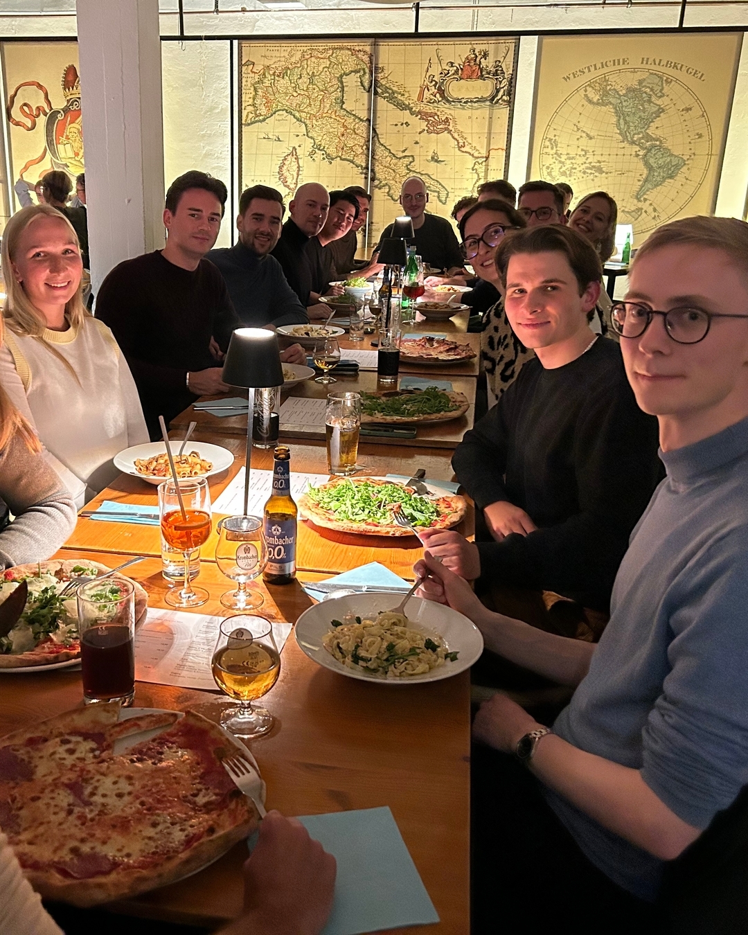 A group of people is sitting at a table with food