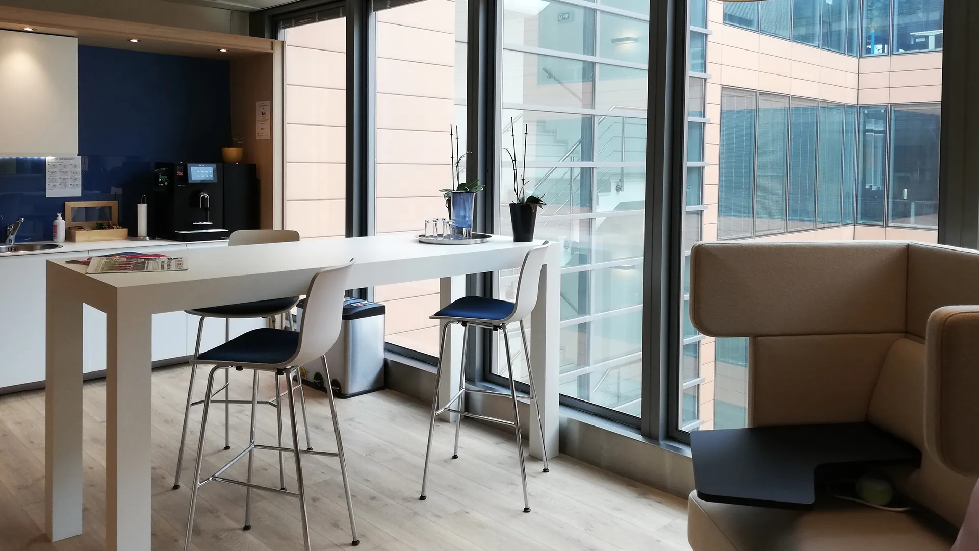 a table and chairs in a room with windows