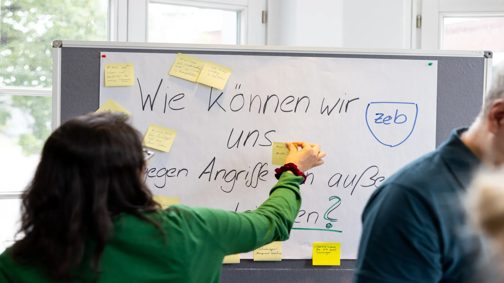 a woman writing on a white board