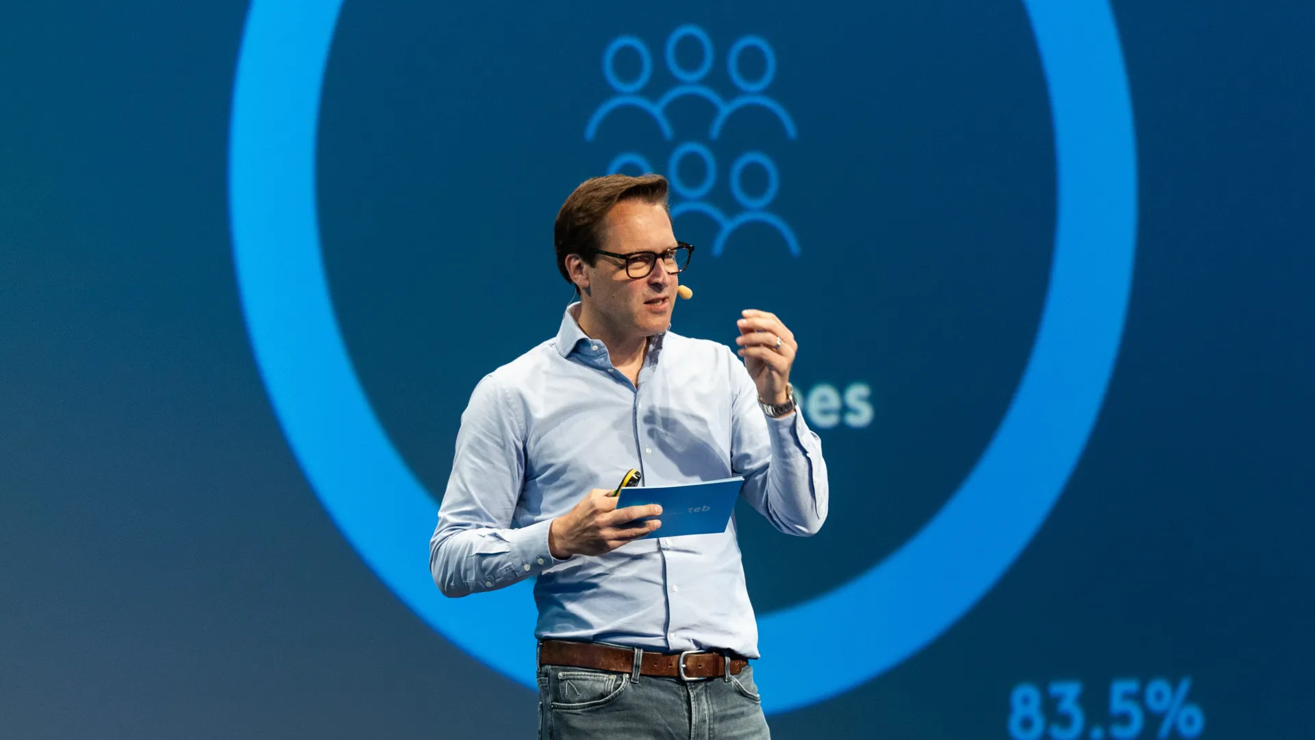 a man holding a blue folder