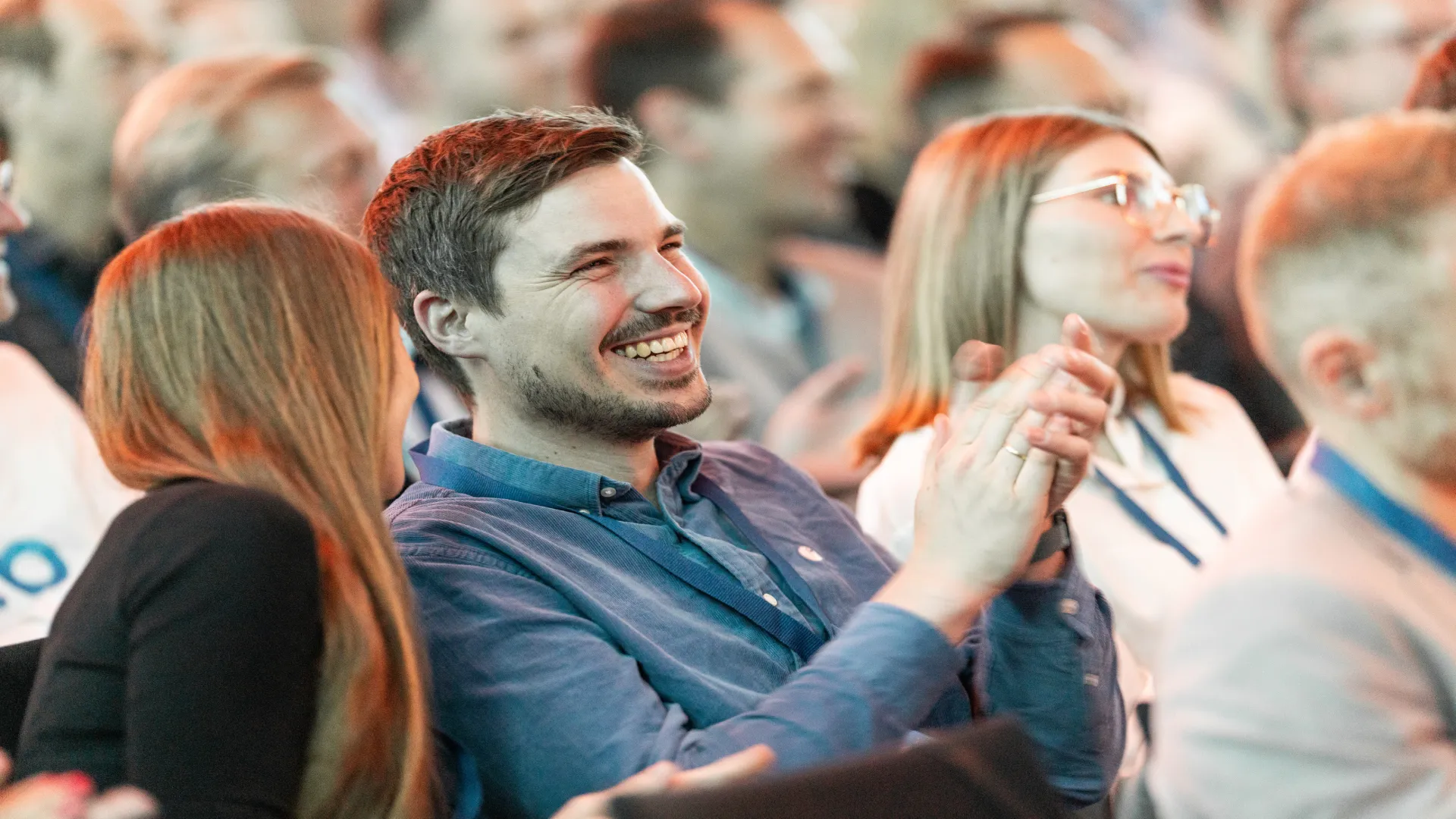 A man clapping and laughing