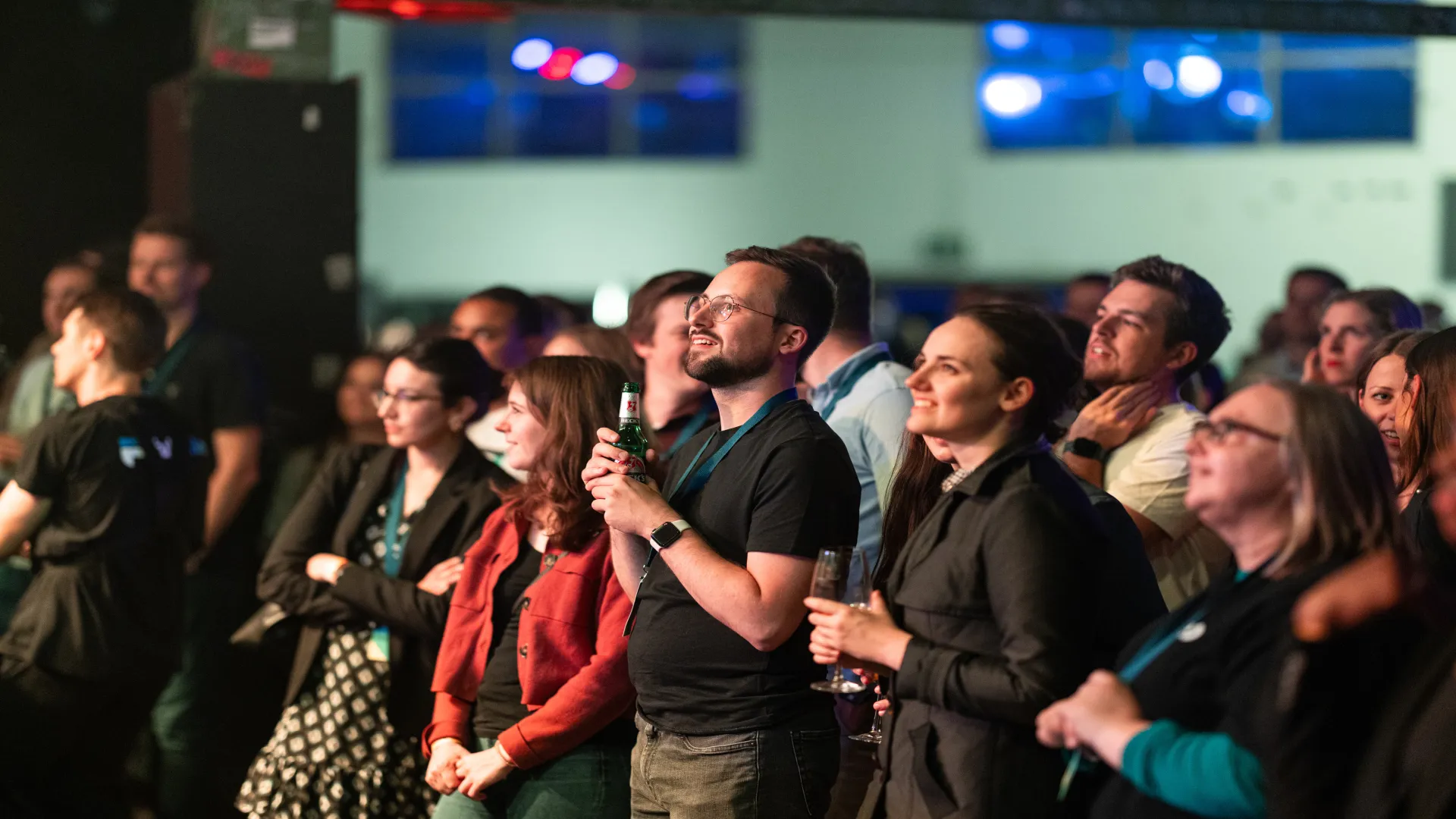 a group of people looking at a stage