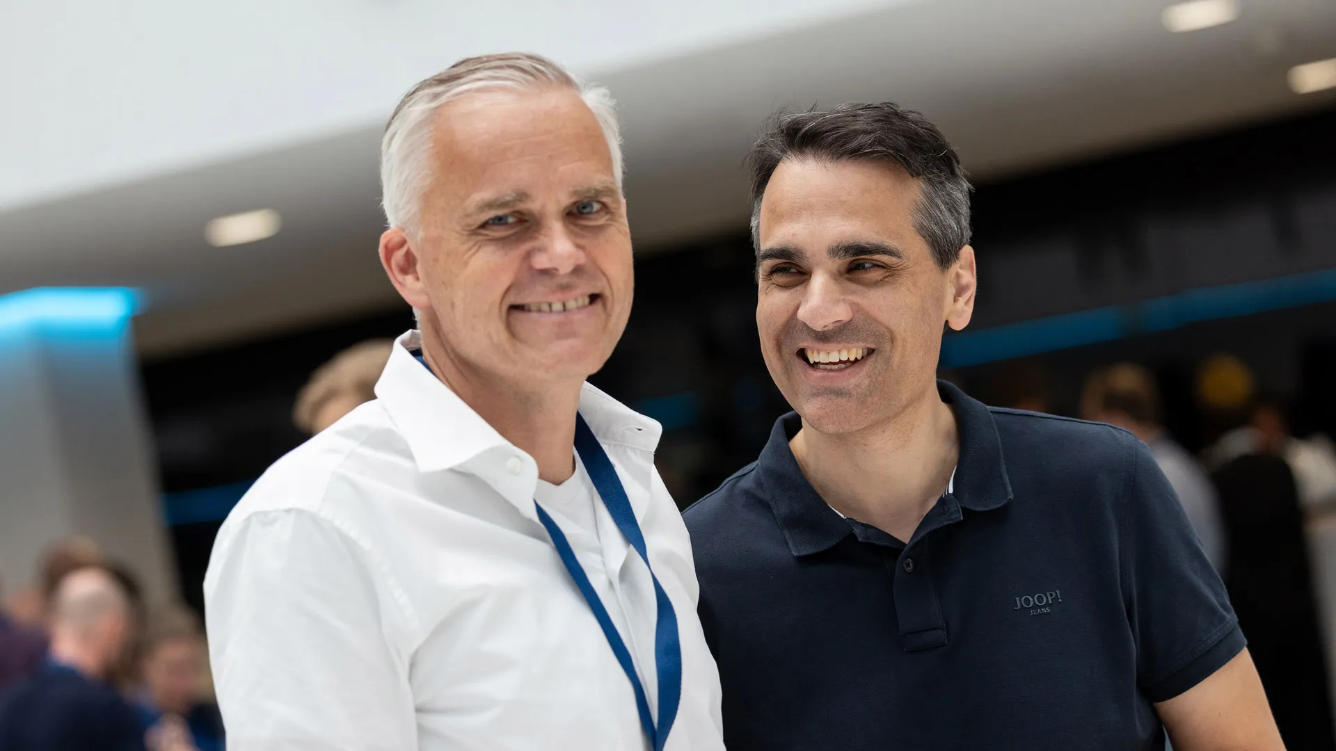 A couple of men smiling