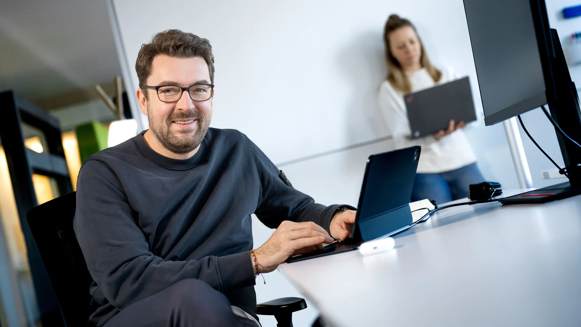 a man sitting at a table with a laptop