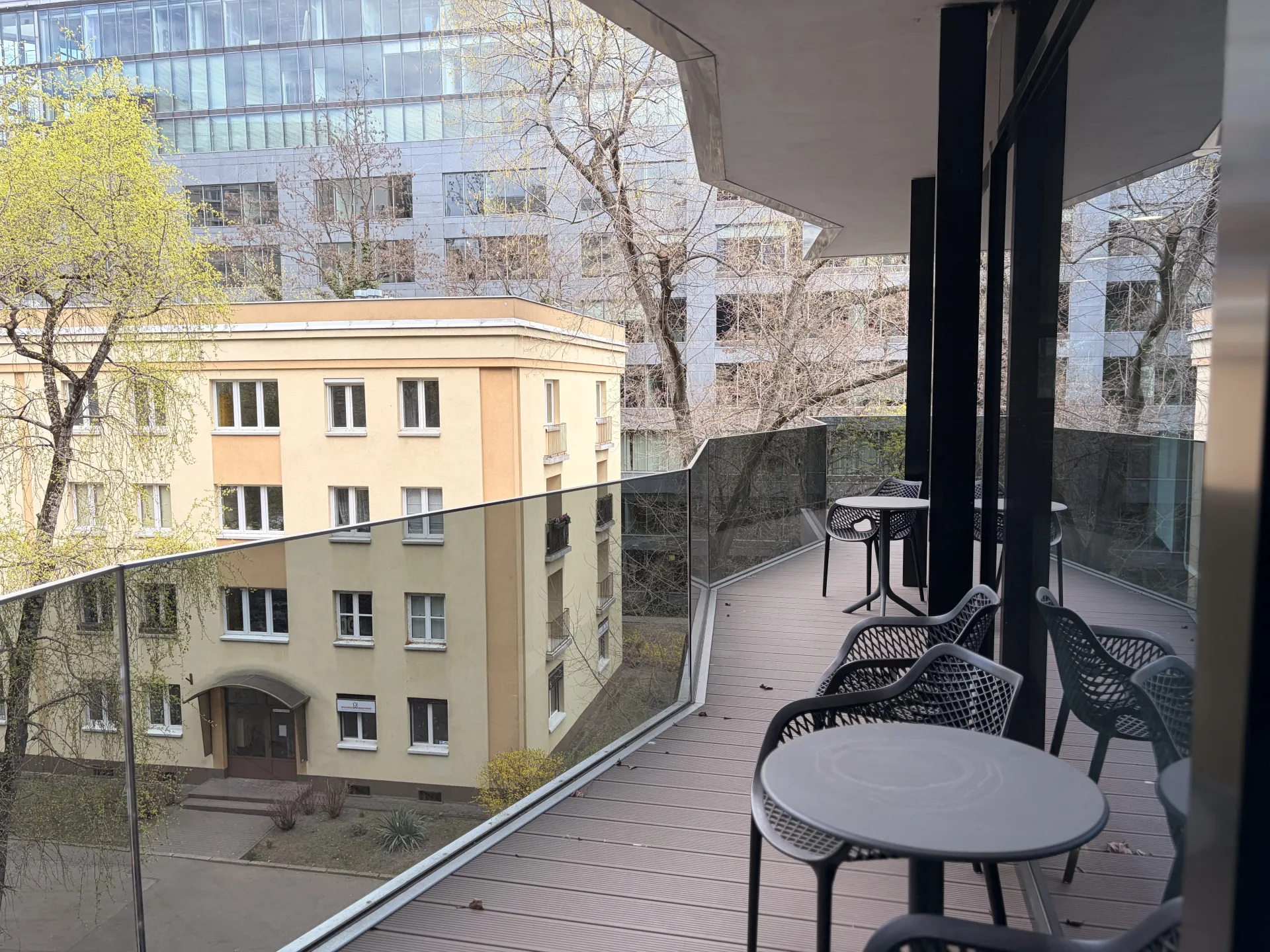 a balcony with tables and chairs