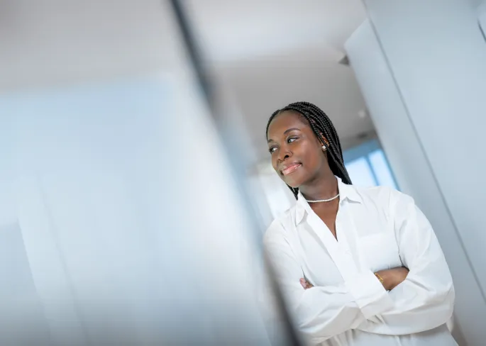 A woman is smiling and is looking to the left.