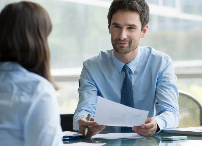 A woman and a man in conversation, office setting