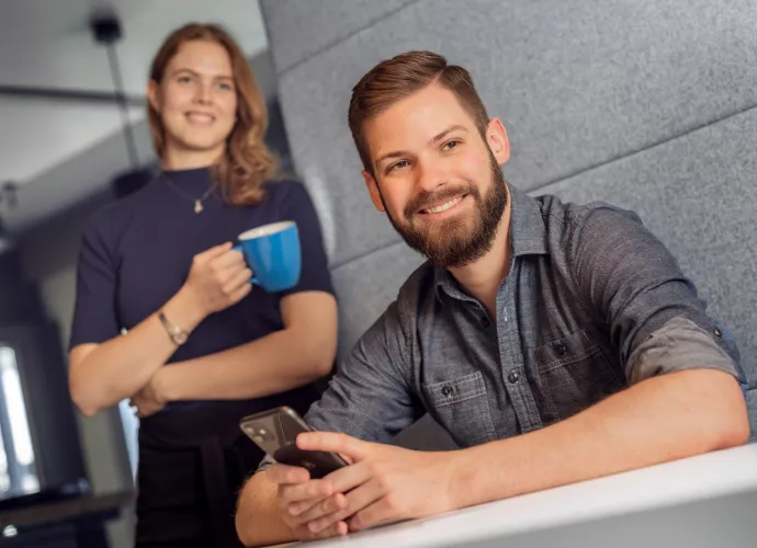 A woman and a man smiling at the camera