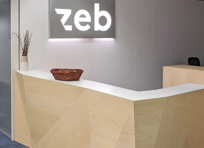 A desk in the lobby of a zeb office