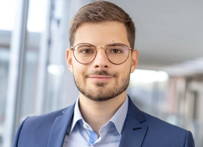 a man wearing glasses and a suit