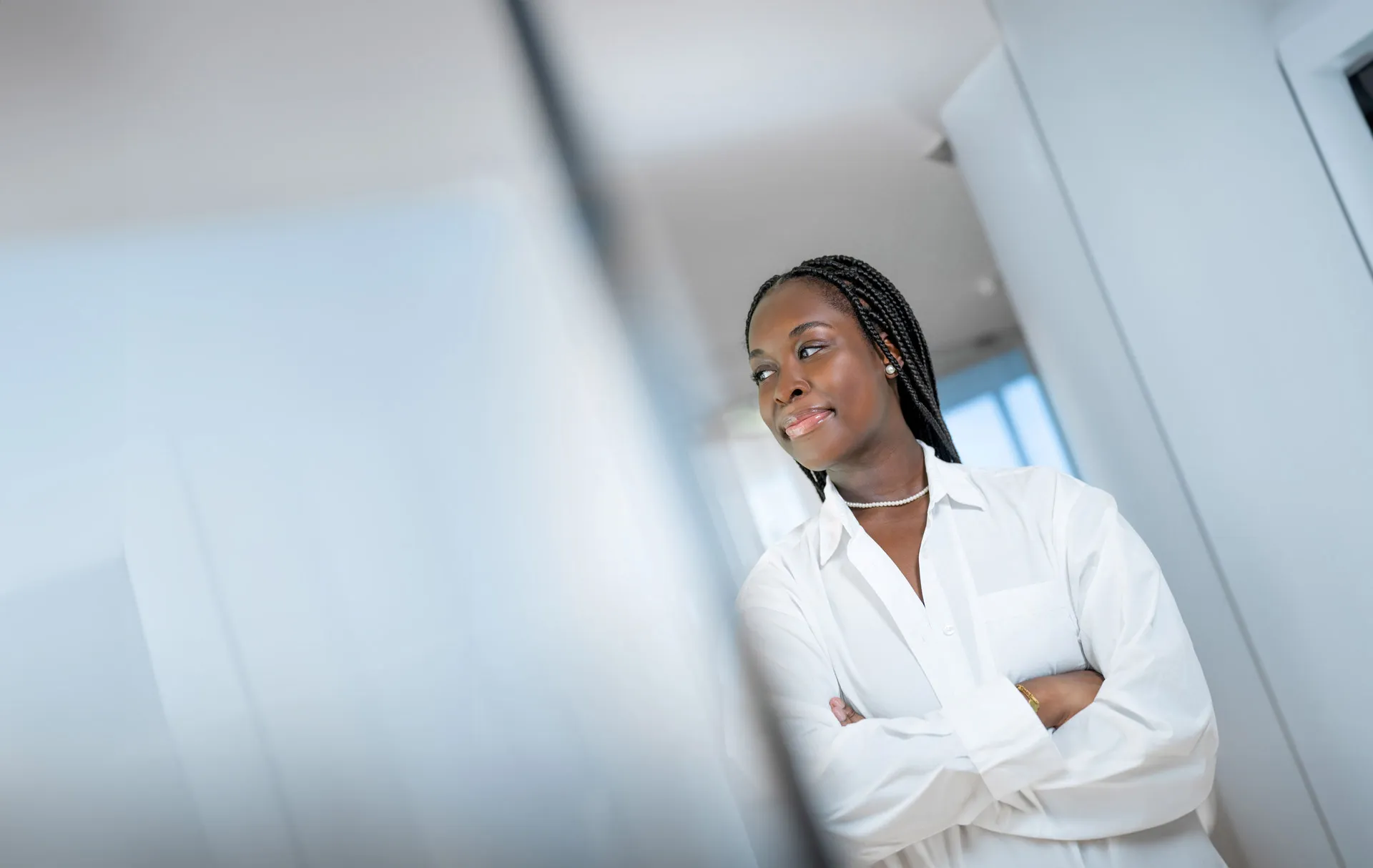 A woman is smiling and is looking to the left.