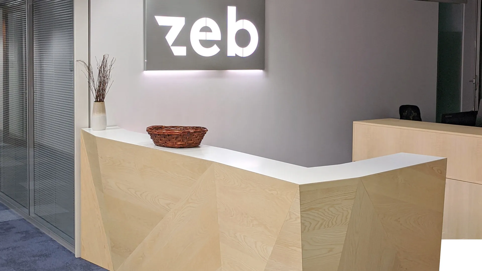A desk in the lobby of a zeb office