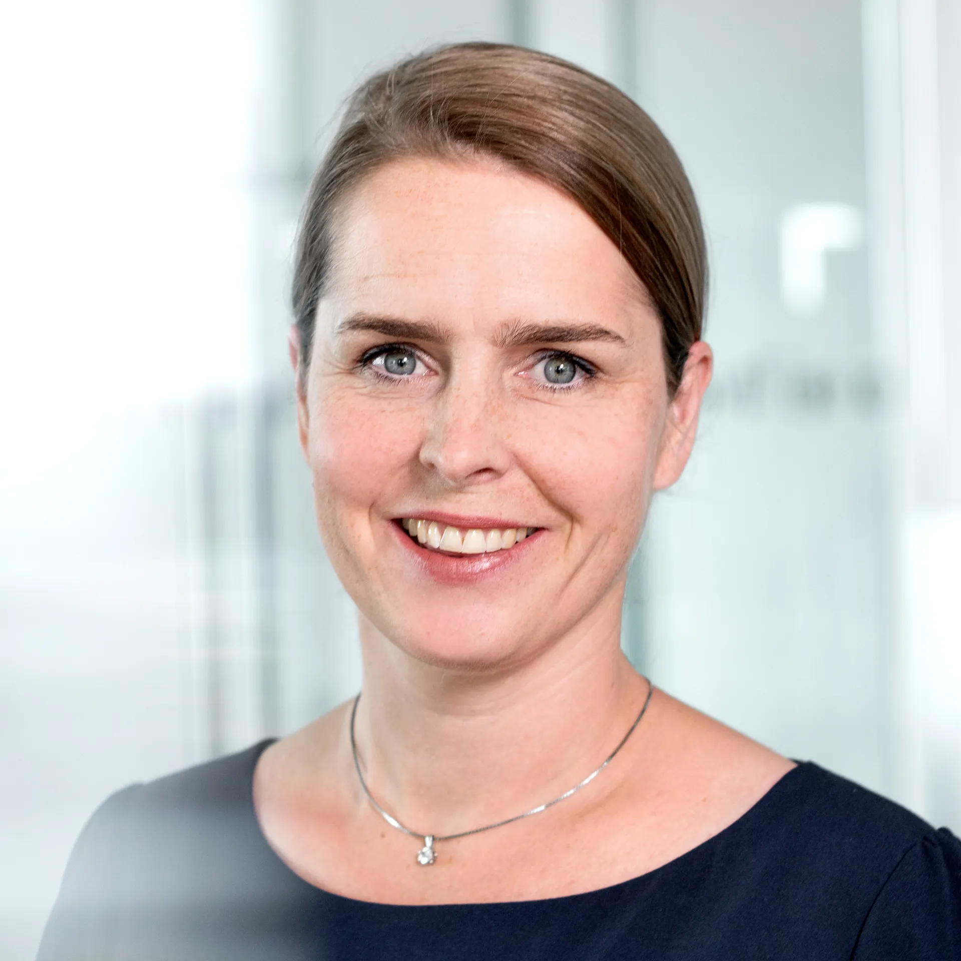 A woman is smiling into a camera.