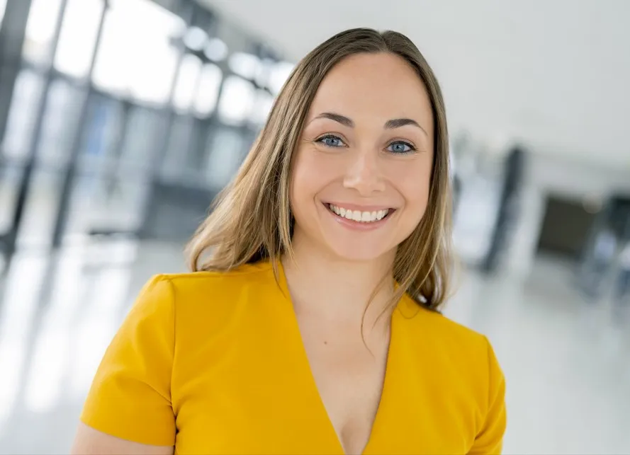 A woman is smiling at a camera.