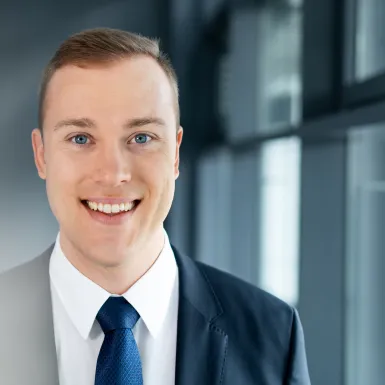 a man in a suit smiling