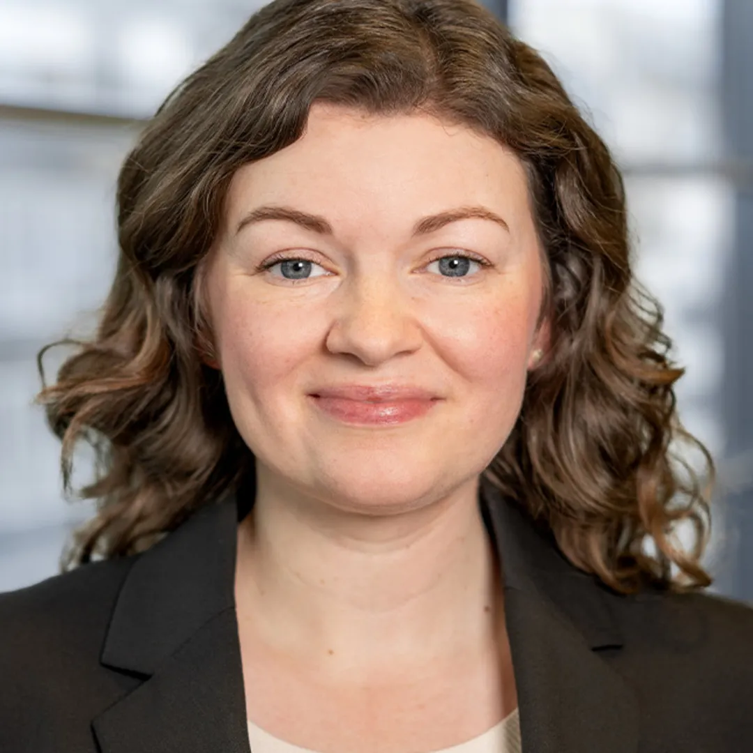 A women is smiling into the camera