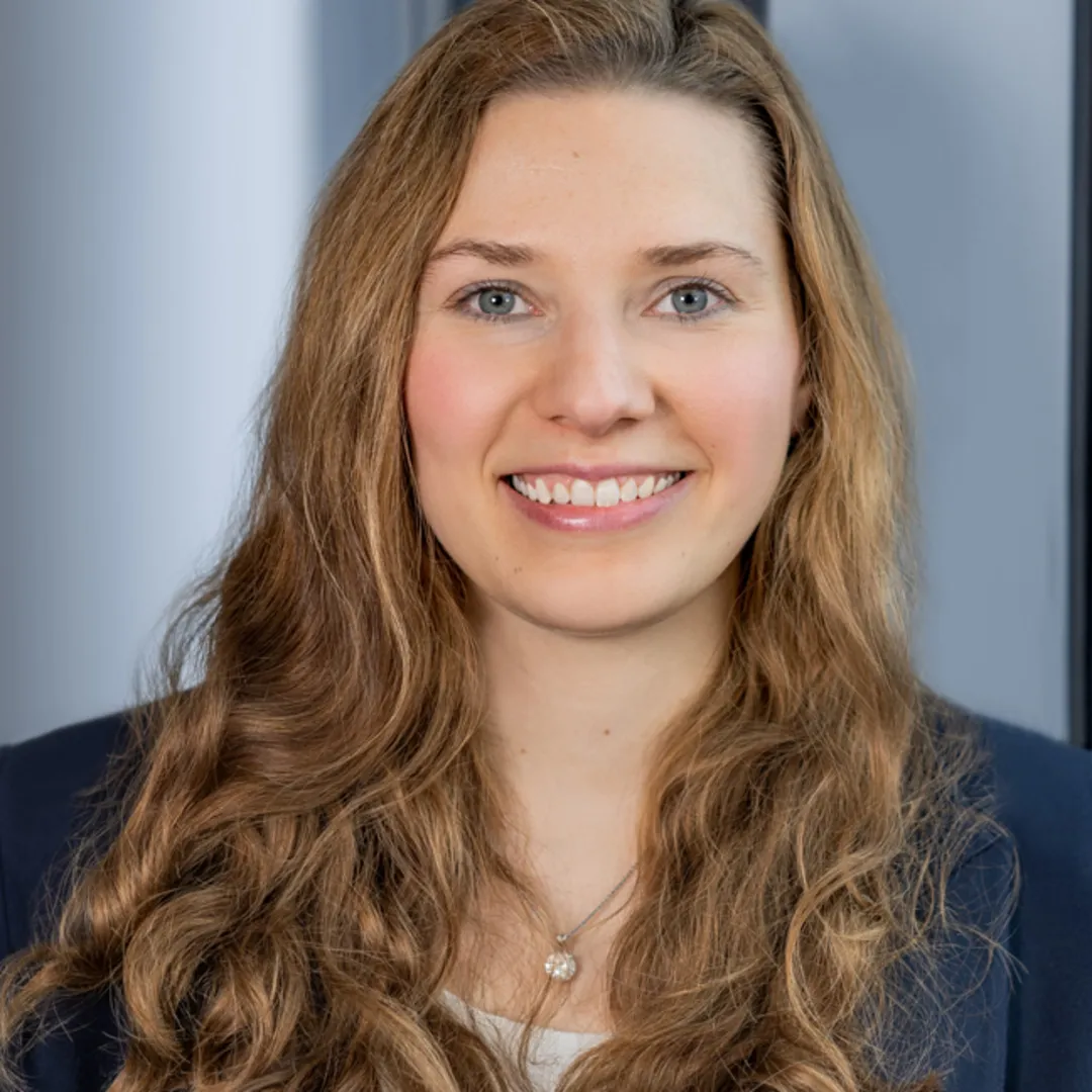 A women is smiling into a camera