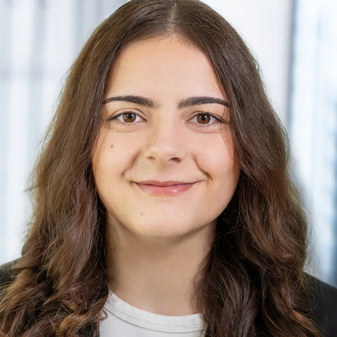 A women is smiling into a camera